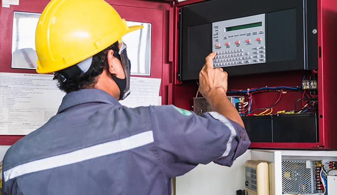 Technician monitoring fire alarms