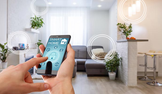 Person using a smartphone app to control smart home devices in a modern living room