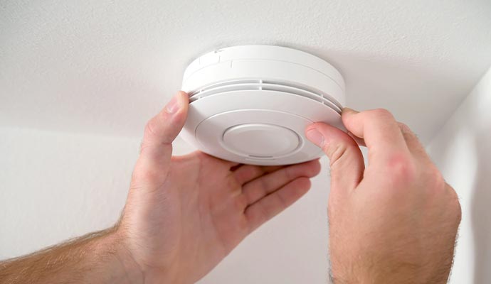 Worker installing carbon detector